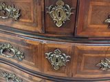 an image of a wooden dresser with many drawers
