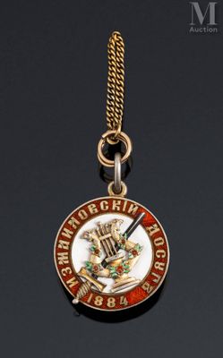 a close up of a medal on a chain on a black surface