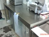 a man that is standing in a kitchen next to a counter