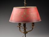 une lampe de table en laiton ancien avec un abat-jour rose sur fond noir