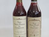 two bottles of wine sitting next to each other on a table