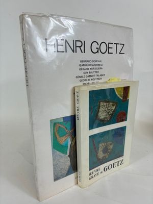 two books are sitting on a white surface next to each other