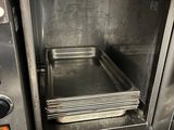 a metal oven with a tray of food inside of it
