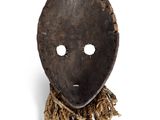 an image of a wooden mask with a chain around it