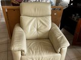 a reclining chair in the middle of a tiled floor