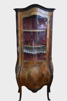 a wooden cabinet with a glass door on it