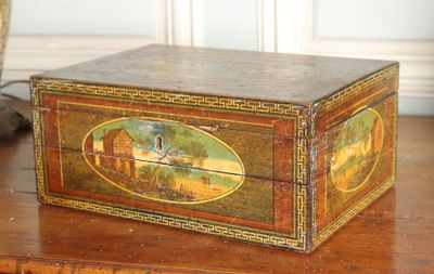 a wooden box with a painting on it on a table