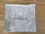 a white bag with a red logo on it sitting on a wooden floor