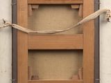 a picture of a wooden frame hanging on a wall