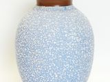 a blue vase with a brown rim on a white background