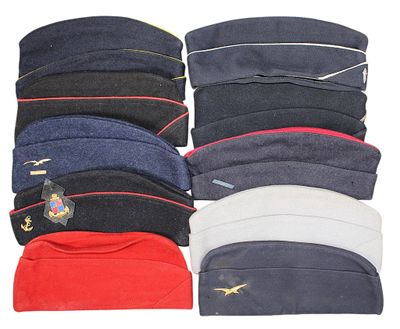 several hats are lined up in a row on a white surface