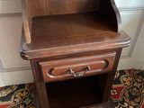 a small wooden table with a drawer on it