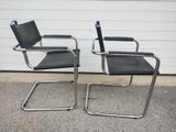 pair of chrome and black leather cantile chairs by marcel knoller for knoller