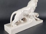 statue of a lion on a stone base on a black background