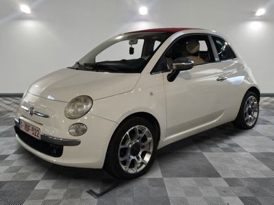 a small white car that is parked on a checkered floor