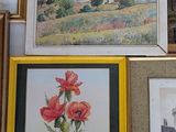 many framed pictures on the wall of this room