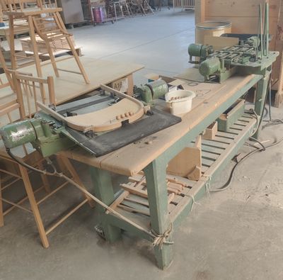 un établi sur lequel sont disposées de nombreuses chaises