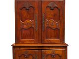an old wooden cabinet with two doors and a drawer underneath it