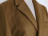 a close up of a coat on a mannequin dummy