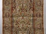 un tapis persan ancien avec un motif floral et des franges