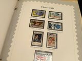 an open book with stamps on it on a table