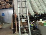 a ladder that is leaning against a wall in a warehouse