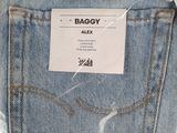 the back pocket of a pair of jeans with a tag on it