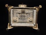 an antique silver and glass box with a flower design on the front
