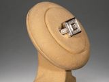 sculpture of a wooden object with a ring on top of it