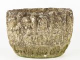a stone planter that is sitting on a white surface