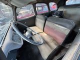 an old car that is sitting in a lot