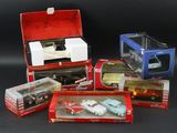 a lot of toy cars in boxes on a black surface
