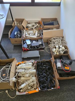 many boxes of wires and other electronics on the floor