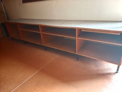 a bed that is sitting on a shelf in a room