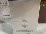 two boxes of chanel perfume sitting on a white surface