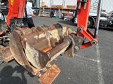 a red excavator that is sitting in the parking lot