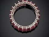 a close up of a red and white ring on a black surface