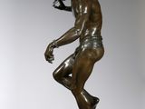bronze statue of a man holding a sword on a marble base