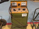 a machine that is sitting on the floor next to a cart