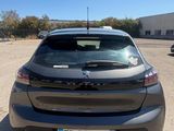 the back end of a grey car parked in a parking lot