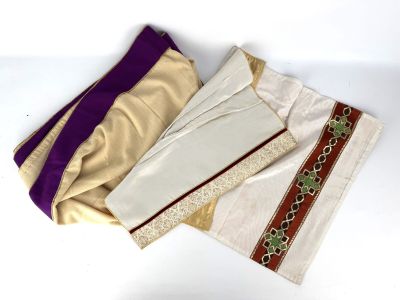 three pieces of cloth are laying on a white surface