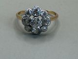 an image of a diamond cluster ring on a white surface