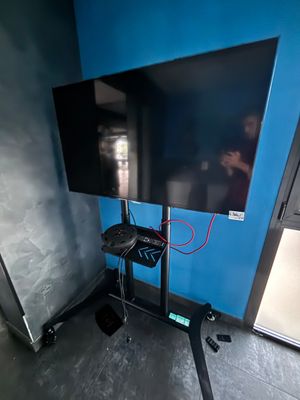 a flat screen tv on a stand in the corner of a room