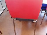 a red chair that has a sticker on the back of it