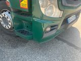 a green truck that is parked in the parking lot