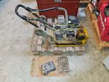 a small lawn mower sitting on a pallet in a garage