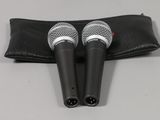 a pair of microphones sitting on top of a black case