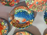 many plates with designs on them sitting on a table