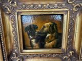 une peinture de deux chiens dans un cadre sur le mur