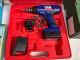 a red box with a drill and other tools in it